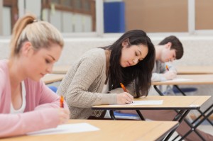 Students taking an exam in exam hall in college